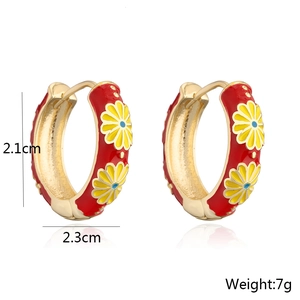 Detail view of retro gold earrings with red enamel daisy patterns and dimensions