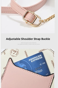 Detail of pink cat-ear card slot and gold buckle on a white crossbody bag