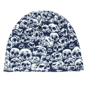 Close-up of navy blue beanie featuring white skull print and knit texture detail