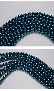 Macro detail of deep blue Tahitian style pearls with high-gloss metallic finish