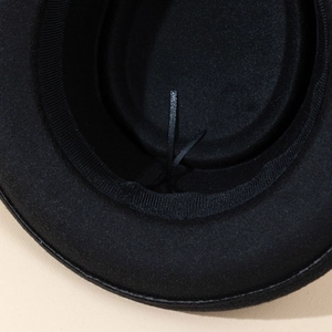 Macro shot of the adjustable sweatband and inner drawstring of this black wool fedora hat