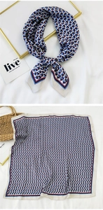 Detail of square silk scarf with red and blue geometric patterns on white background