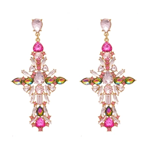 Vintage gold cross drop earrings with pink rhinestones and crystals on white background