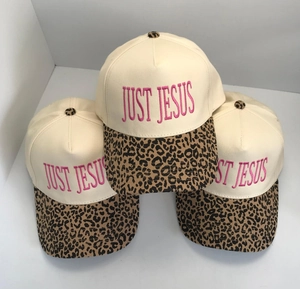 Close-up of baseball caps with leopard print brim and pink Just Jesus embroidery