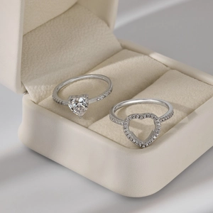 Detail of two S925 sterling silver heart rings with cubic zirconia in a jewelry box
