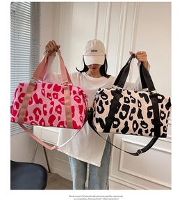 Dual cow print travel bags in pink and cream with high-density fabric handles and straps