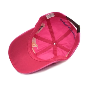 Detail of pink cotton baseball cap interior showing wash label and six-panel stitching