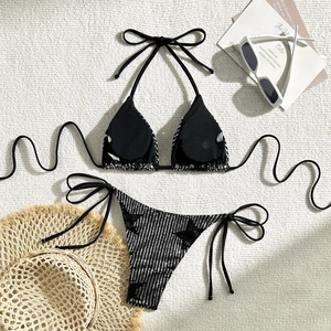 Detailed flat lay of black sequin bikini set with sun hat and sunglasses for vacation
