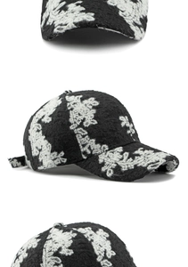 Detail view of ethnic floral jacquard baseball cap with monochrome embroidery and curved brim