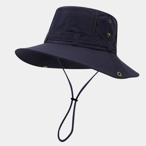 Detail of navy blue outdoor sun hat featuring side metal eyelets and adjustable chin strap