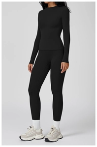 Full view of black long sleeve yoga set featuring slim fit top and high waist leggings