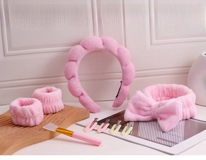Pink plush spa set with twisted headband, wristbands and silicone mask brush details