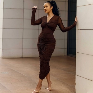 Detail view of V-neck ruching and mesh long sleeves on a dark brown bodycon dress