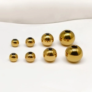 Various sizes of polished golden stainless steel round beads with hole for DIY jewelry