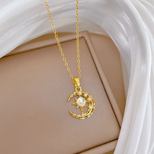 Detail of gold moon and star pendant with opal gemstone and pavé rhinestones