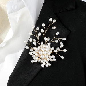 Elegant pearl tree brooch with gold metal wire on a black suit blazer for women