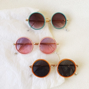 Fashionable round frame sunglasses for kids in pink, green, and orange with metal frames