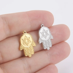 18k gold and silver Hamsa Hand pendants with Star of David held on fingers