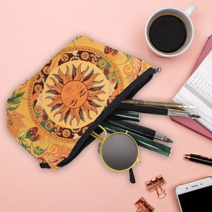 Vintage yellow floral toiletry bag with sun and moon patterns on a pink background