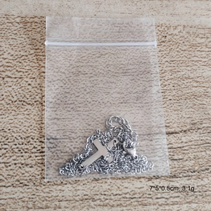 Delicate stainless steel cross pendant necklace in silver finish with link chain