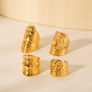Set of four textured gold stainless steel rings with hammer and weave patterns