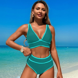 Detail of high-waist bikini bottoms and sport top with contrast piping in turquoise