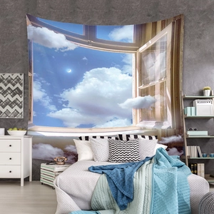 Detailed view of bohemian window landscape tapestry hanging over a bedroom bed with clouds