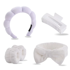 Close-up of a 5-piece purple plush headband and white spa wristband set for face washing