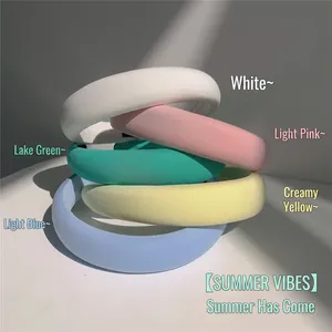 Macro detail of thick sponge headbands in five soft macaron colors with plush fabric texture