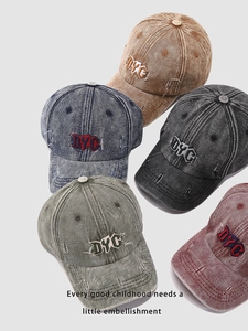 Detailed view of vintage washed denim caps with DYC embroidery in five stylish colors