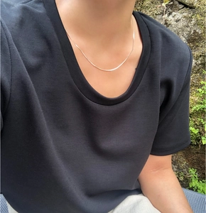 Close-up of minimalist 925 sterling silver snake chain necklace on female model