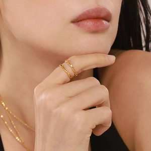 Gold stainless steel hollow rings and chain necklace set worn by a female model