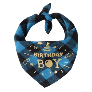 Detailed view of blue and black plaid pet birthday bandana with gold Birthday Boy print