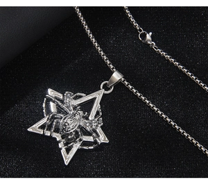 Detailed close-up of a silver spider inside a hexagram pendant on a box chain necklace