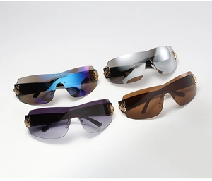 Detail view of four colored frameless oversized sunglasses with butterfly metal accents