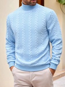 Detail of light blue cable knit texture on a men's high neck sweater with soft lighting