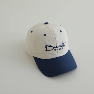 Close-up of kids' quick-dry baseball cap with Burnette NESOE navy embroidery and brim