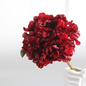 Close-up of deep red vintage faux hydrangea in a white vase for home decor
