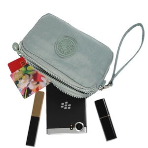 Three-layer light green nylon crossbody phone bag with wrist strap and zipper closure