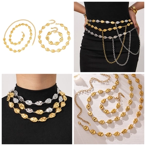 Macro details of 18k gold plated textured oval chain link necklace and waist chain set