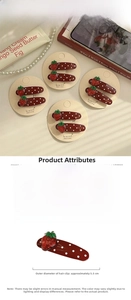 Detailed view of red strawberry hair clip with white dots and sparkling rhinestone accents