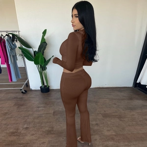 Detail of dark brown long sleeve crop top and matching high waist flared pants on model