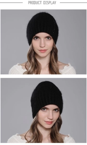 Detail showing a black knit rabbit hair hat with stylish pearl embellishments on a model