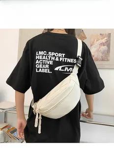 Detailed view of off-white crossbody bag featuring synthetic leather texture and adjustable strap