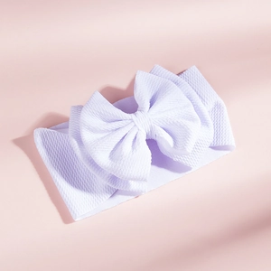 Detail of light purple waffle knit baby headband with a large double-layered bow