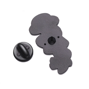 Detail of cartoon astronaut brooch back with matte metal texture and rubber clutch