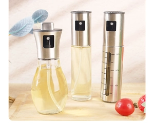 Detail showing glass and stainless steel oil spray bottles with capacity scale markings