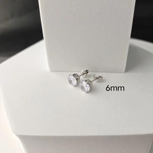 Detailed view of 6mm six-prong cubic zirconia stud earrings in polished stainless steel