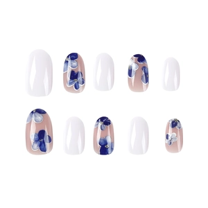 Short oval press-on nails featuring blue floral patterns and white solid colors