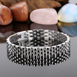 Detailed view of silver stainless steel watch-style bracelet with folding clasp on dark stone
